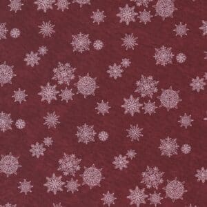 Maroon fabric with white snowflake patterns scattered throughout.