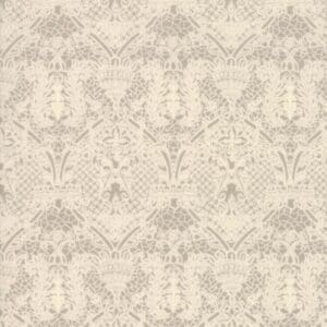 Intricate beige damask wallpaper with floral and ornamental patterns.