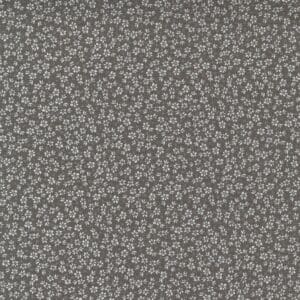 Gray fabric with a small floral pattern in white.