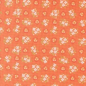 Orange fabric with white floral pattern.