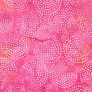 Pink fabric with circular dotted patterns in orange and white.