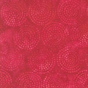 Close-up of textured red fabric with circular patterns.