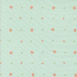 Light green fabric with small orange floral prints scattered evenly.