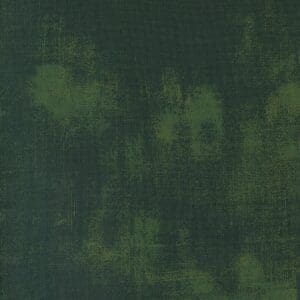 Dark green textured fabric with subtle yellowish patterns.