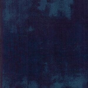 Abstract dark blue textured background with lighter blue patches.