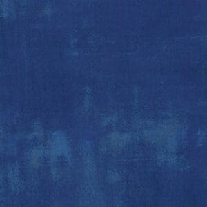 Abstract blue textured background with varying shades and subtle patterns.