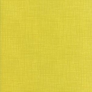 Textured yellow fabric with a woven pattern.