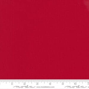 Solid red fabric with a measuring ruler at the bottom.