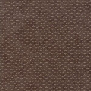 Close-up of textured brown fabric with a subtle geometric pattern.