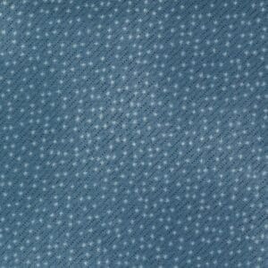 Close-up of textured blue fabric with small white dots.