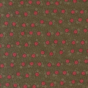 Close-up of olive green fabric with a pattern of small red dots.