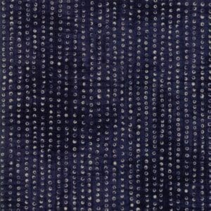 Close-up of dark blue fabric with a dotted texture pattern.