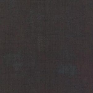 A dark, textured surface with subtle variations in shading.