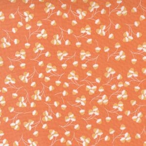 Orange fabric with small white floral pattern.