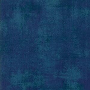 Textured blue fabric with a distressed look.