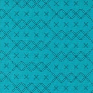 Blue fabric with a geometric pattern of diamonds and X shapes.