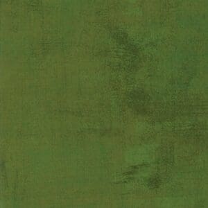 Textured green surface with subtle color variations.