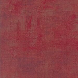 Red textured fabric with subtle variations in shading.