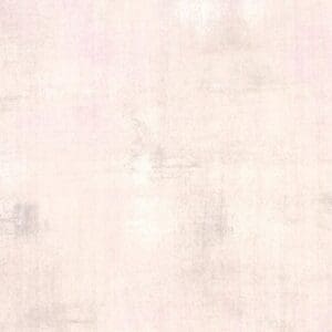 Soft pink textured background with subtle gray accents.