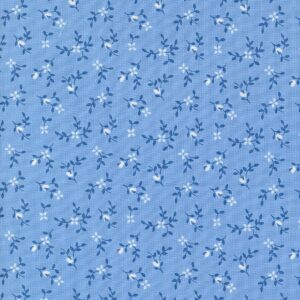 Blue fabric with small floral pattern in white and navy.