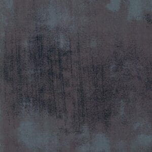 Abstract textured surface with dark and muted tones.