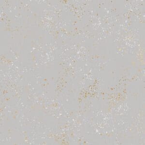 Close-up of a light gray surface with small scattered spots and speckles.
