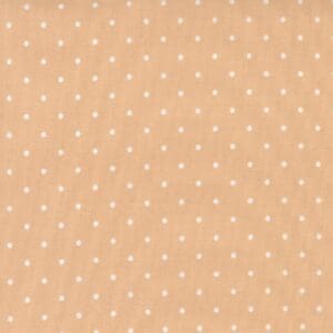 Beige fabric with small white polka dots pattern.