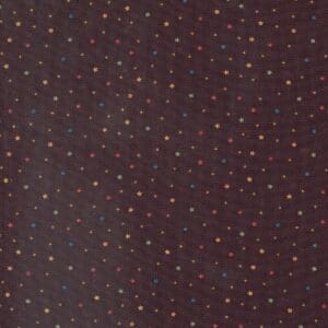 Close-up of a dark fabric with a pattern of small, evenly spaced red dots.