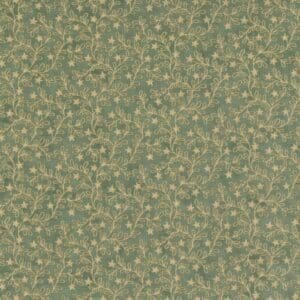 Close-up of textured green fabric with small white and beige dots.