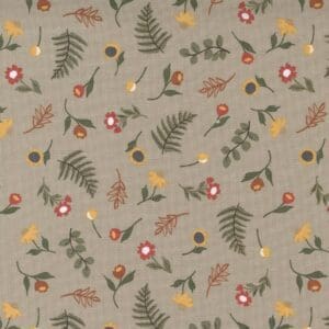 Beige fabric with floral and fern patterns in earthy tones.