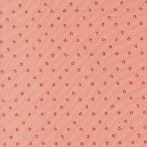 Patterned fabric with small floral motifs on a peach background.