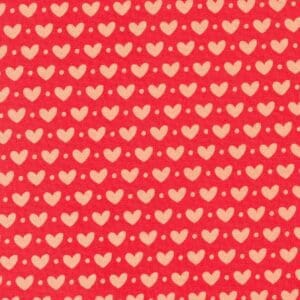 Red fabric with a repeating pattern of small hearts and dots.