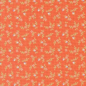 Orange fabric with a delicate floral pattern in white and light green.