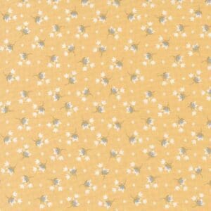 Yellow fabric with small white floral pattern.