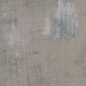 Textured gray and beige concrete wall with subtle stains.