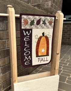 A fall-themed welcome banner with pumpkins and leaves.