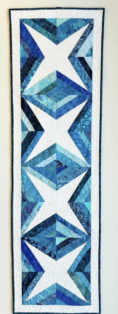 Blue and white geometric pattern quilt.