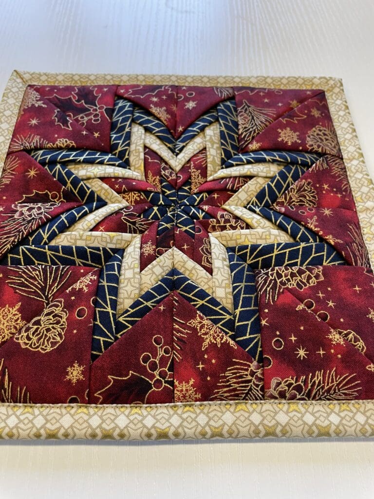 Quilted star pattern on red fabric background.