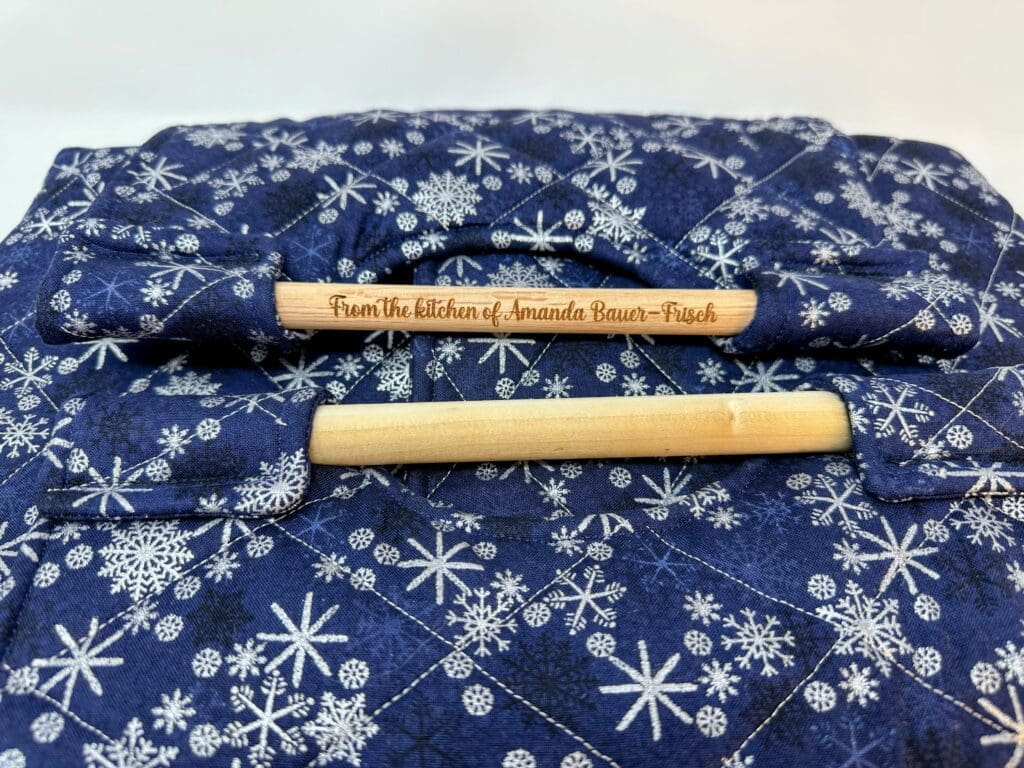 Blue quilted fabric with snowflake pattern.