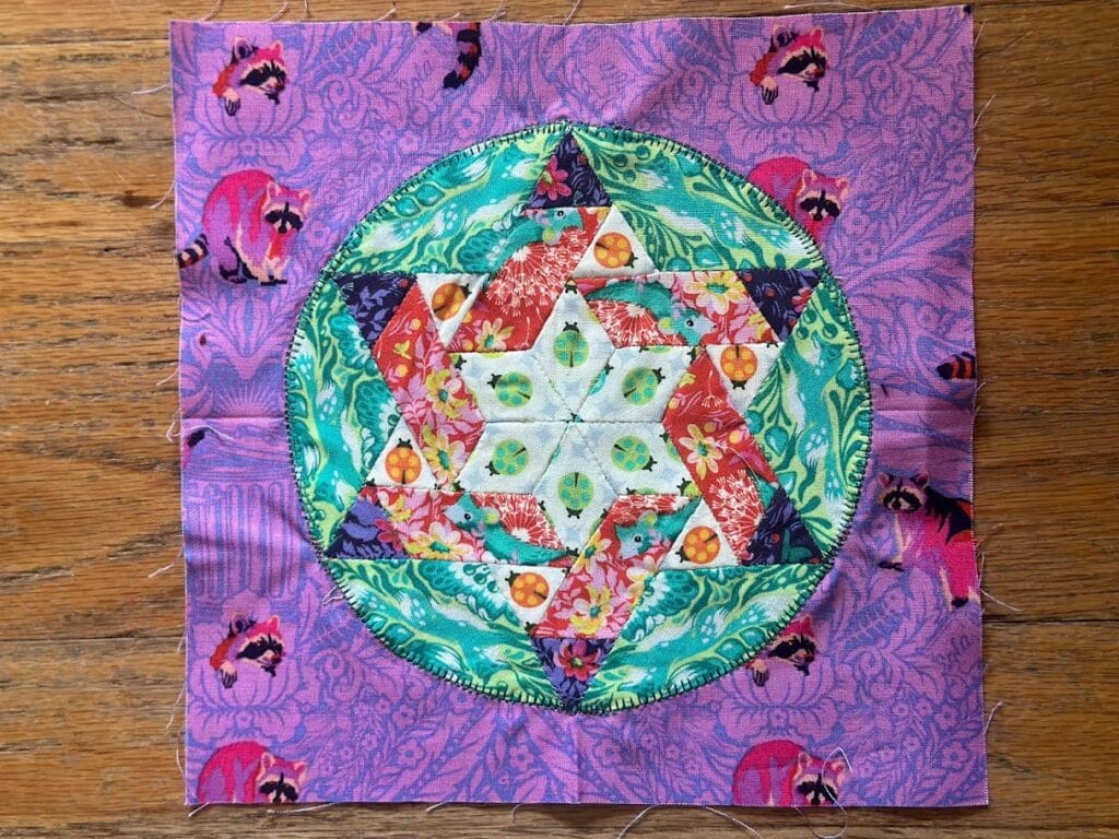 Colorful quilt block with geometric star pattern.