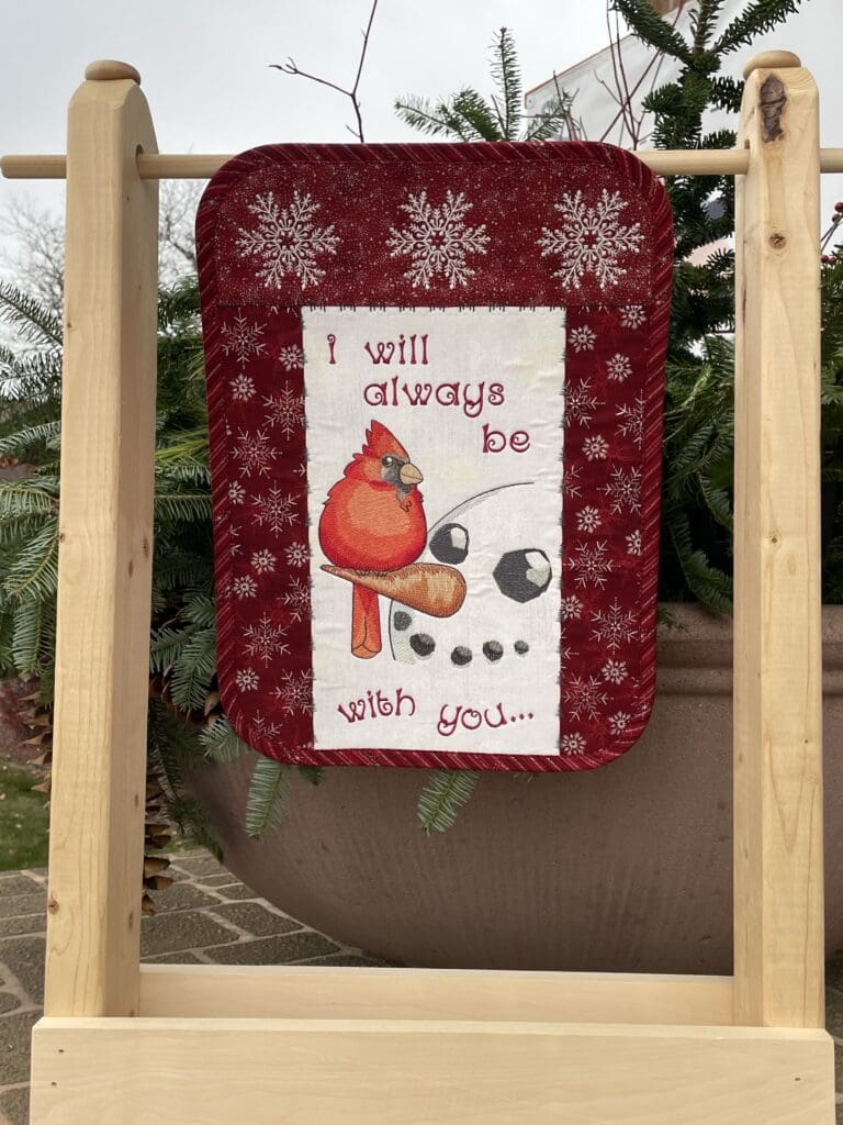 Winter lawn flag with snowman and cardinal