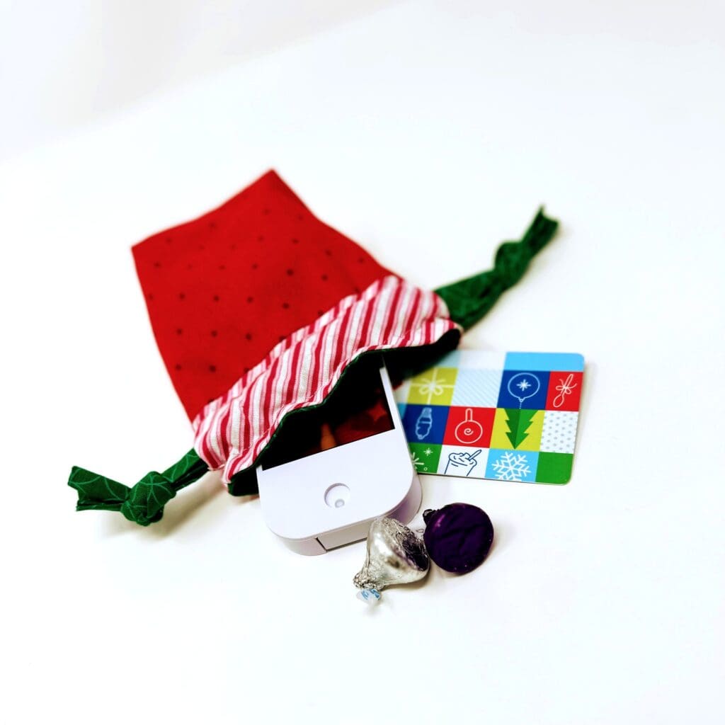 Red gift bag with small items spilling.