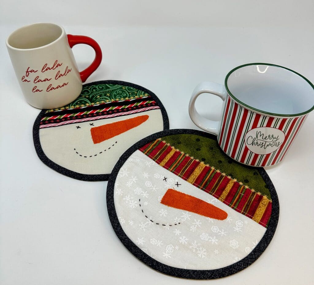 Christmas mugs with snowman face coasters.