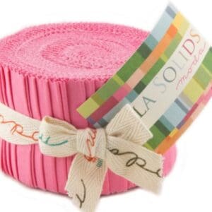 Pink fabric roll with colorful label.