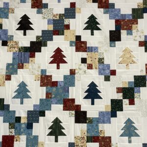 Patchwork quilt with colorful tree blocks
