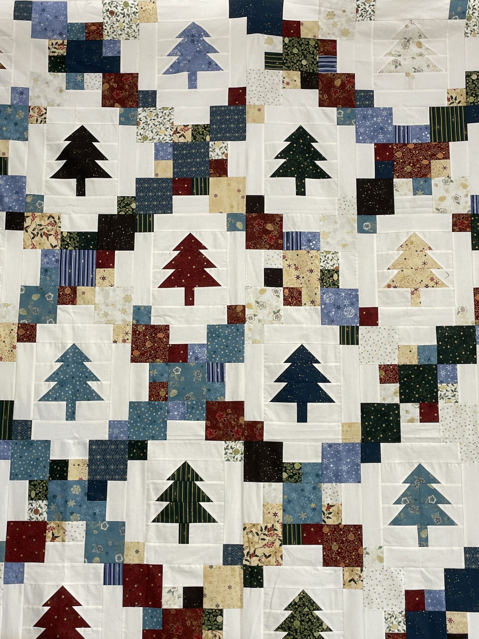 Patchwork quilt with colorful tree blocks