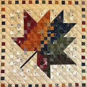 Patchwork maple leaf quilt in autumn colors