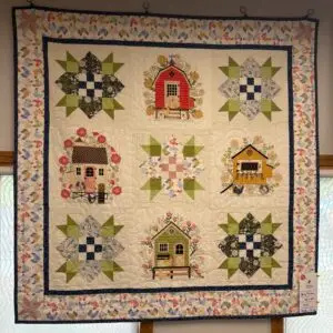 Handmade quilt with houses and star blocks