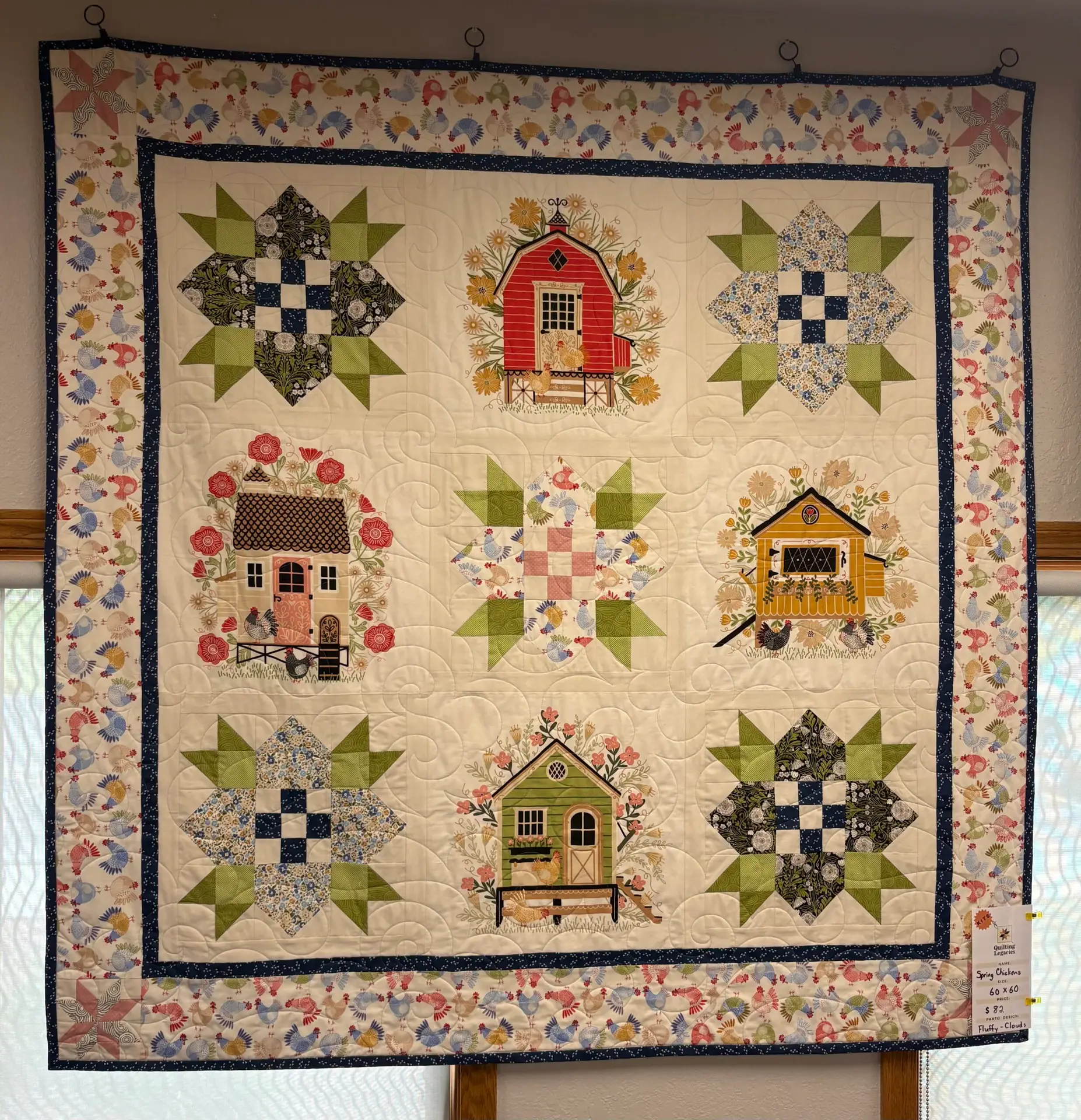 Handmade quilt with houses and star blocks